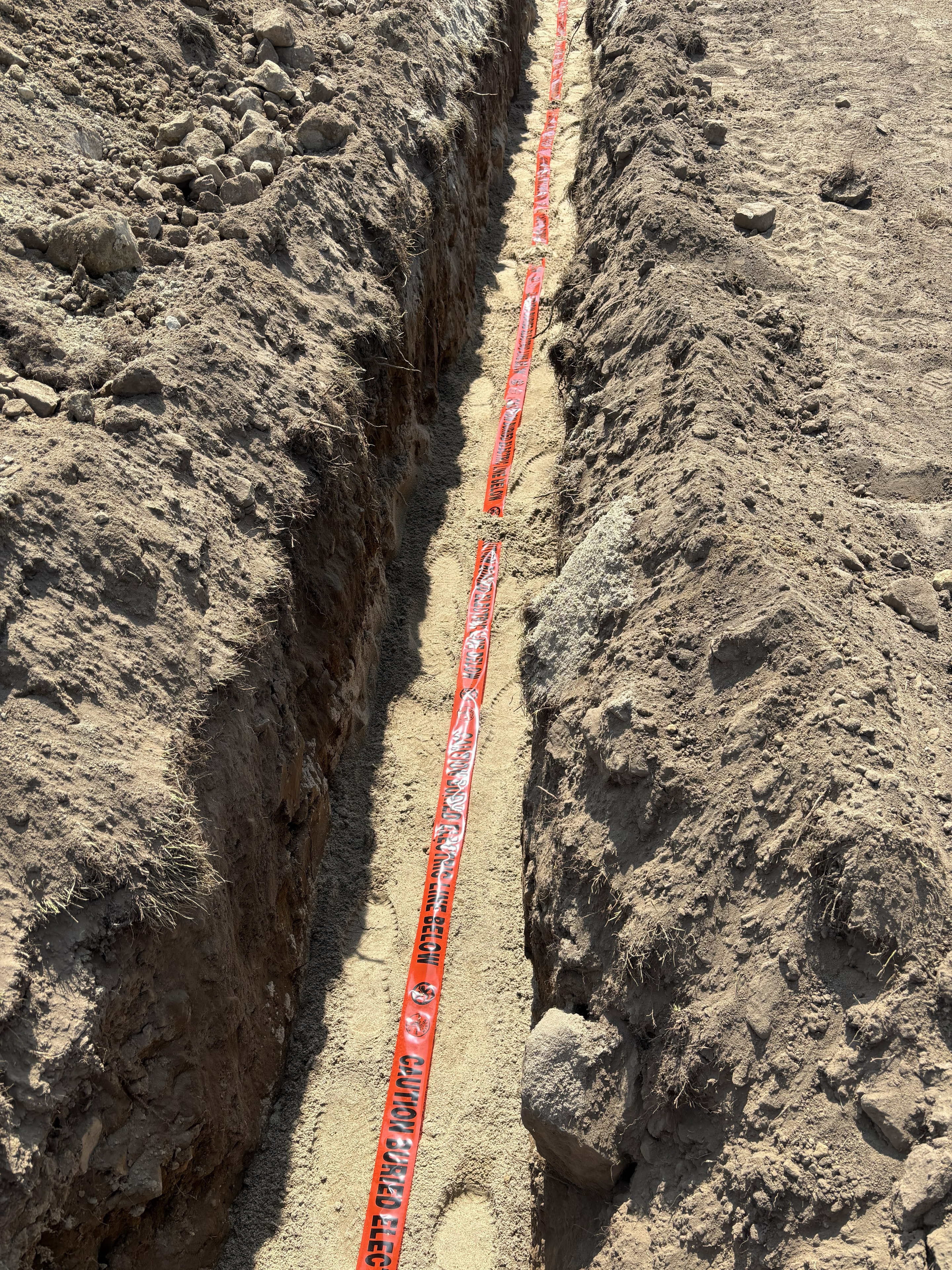 Underground service installation with warning tape